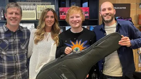 Music World Ed Sheeran with members of the Fender family in Music World