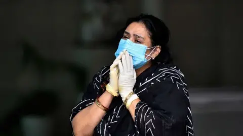 Getty Images A woman grieving for a relative who has died from Covid-19