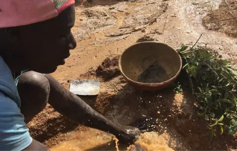 A man panning for tin