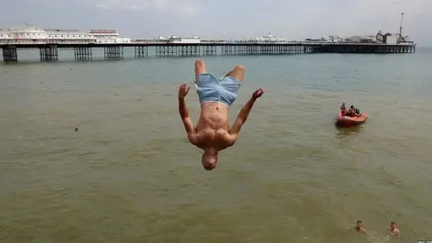 Reuters Man jumping into the sea in Brighton