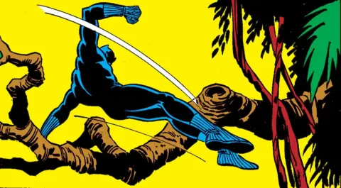 Marvel Black Panther leaps across a wood with a tree branch behind him