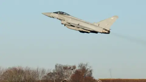 Reuters A Typhoon takes off from RAF Coningsby in Lincolnshire during a visit by Prime Minister Rishi Sunak following the announcement that Britain will work to develop next-generation fighter jets with Italy and Japan.