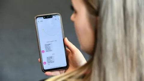 PA Media girl with exam results on phone