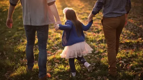 Getty Images File image of a little girl and her parents