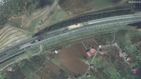 Maxar Technologies A satellite imagery of fields and roads in Turkey with a fault line cutting across them