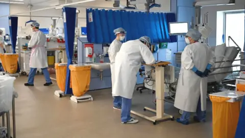 Getty Images Staff at University Hospital Monklands attend to Covid-positive patients on the ICU ward on February 5, 2021