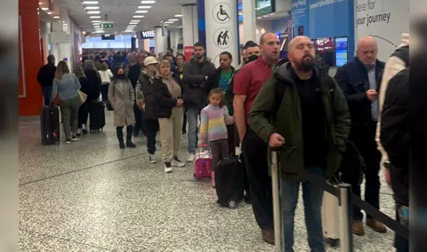 Rebecca Young/PA Media  Long queues of holidaymakers at Birmingham Airport