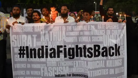Getty Images Protesters taking part in a candlelight vigil in Ahmedabad on 16 April 2018 in support of rape victims following cases in Jammu and Uttar Pradesh state.