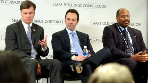 Getty Images Alan J. Lacy, vice chairman and CEO of Sears Holdings; Edward S. Lampert, chairman, Sears Holdings; and Aylwin B. Lewis, president of Sears Holdings and CEO of Kmart and Sears Retail, answers following approval of the merger of Sears, Roebuck and Co. and Kmart Holding Corporation by shareholders of both companies March 24, 2005