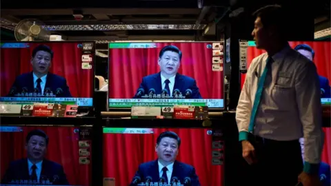 AFP Image shows television sets showing a news report on China President Xi Jinping's speech