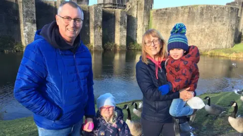 Don Darch, 65, and Nesta Darch, 63, from Pontypridd with their grandchildren Berwyn and Heti