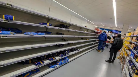 EPA Empty shelves at supermarket as people stockpile due to the fear of the new coronavirus in Palermo, Italy, 25 February 2020. Italian authorities say that there more than 200 confirmed cases of COVID-19 disease were registered in the country, with at least seven deaths. Precautionary measures and ordinances to tackle the spreading of the deadly virus included the closure of schools, gyms, museums and cinemas in the affected areas in northern Italy. EPA/Igor Petyx