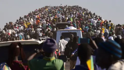 AFP People crossing the bridge