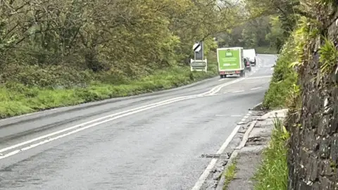 BBC Vehicles on the A390 near the site of a fatal crash