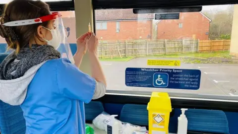 Alliance for Better Care A nurse prepares a syringe
