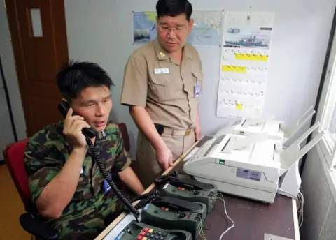 AFP/Getty Images This file photo taken on August 10, 2005 shows South Korean Lieutenant Choi Don-Rim (L) communicating with a North Korean officer during a phone call at a military office near the Demilitarised Zone (DMZ), separating North and South Korea, in Paju, north of Seoul, as the two countries tested a hotline aimed at helping avoid naval confrontations in the Yellow Sea.