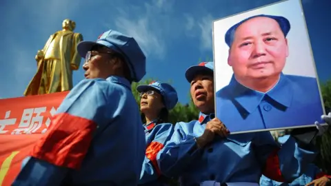 Getty Images People with poster of Mao Zedong