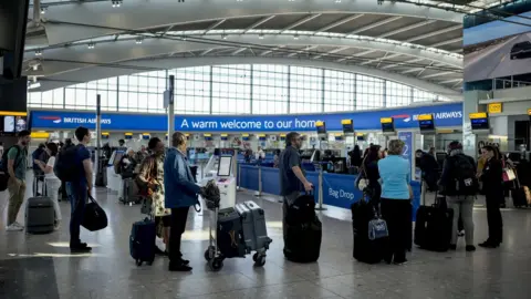 Getty Images People queuing at Heathrow Airport