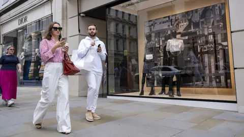 Getty Images People walk down Bond Street