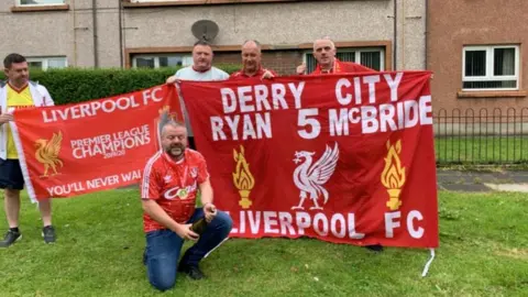 Eamonn McBride Eamonn McBride with other members of the 1st Derry Official Liverpool Supporters' Club