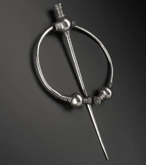 NAtional Museums Scotland Penannular silver brooch with thistle terminals, the balls undecorated, with a series of mouldings on either side, from Skaill.jpeg