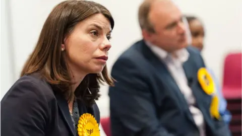 Getty Images Sarah Olney and Tim Farron visit Kingston Hospital in London