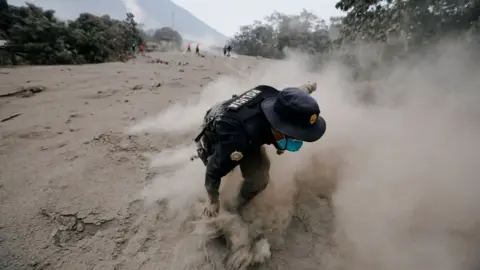 Reuters A police officer stumbles while running away after a the Fuego volcano spew new pyroclastic flow in the community of San Miguel Los Lotes in Escuintla, Guatemala, June 4, 2018