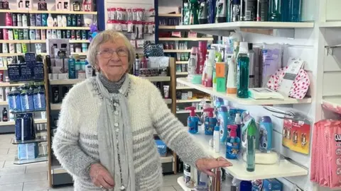 BBC Betty Pritchard inside Watkin-Davies pharmacy