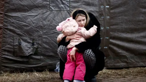 Reuters Ukrainian woman at refugee camp in Poland.