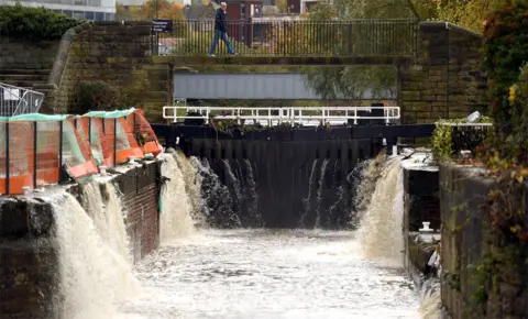 AFP Flood water runs off into a canal