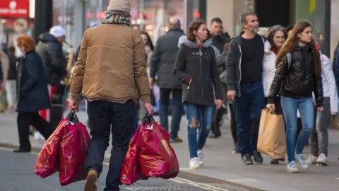 Getty Images man with carrier bags