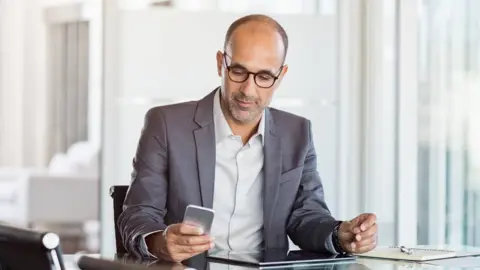 Getty Images Businessman using mobile phone