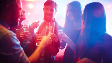 Getty Images Group of friends in a nightclub
