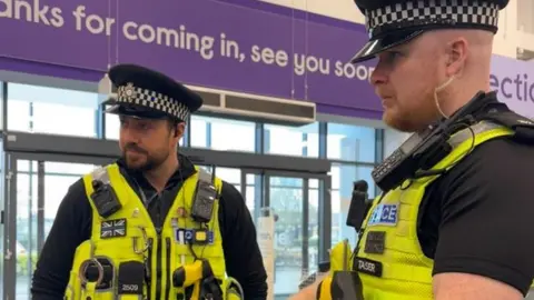 Cambridgeshire Constabulary Officers providing crime prevention advice to Currys in Peterborough