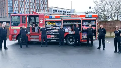 WMFS Firefighters with presents