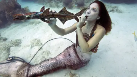 BOB CARE/AFP/Getty Images Mariah Reynolds, garbed as a mermaid