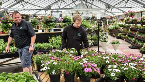 Getty Images Two garden centre workers