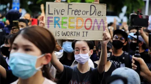 EPA A pro-democracy protester holds up a placard during a rally against the state of emergency at Ratchaprasong district in Bangkok, Thailand, 15 October 2020