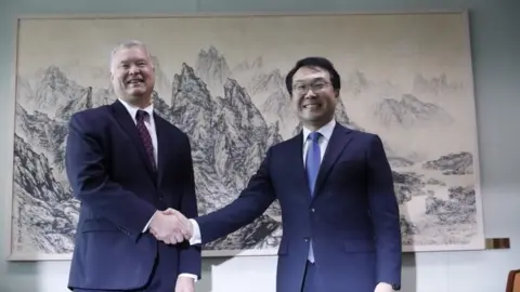 AFP US special envoy for North Korea Stephen Biegun shakes hands with his South Korean counterpart Lee Do-hoo