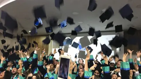Sakarya University Graduates throw their mortar board hats in the air