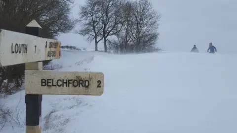 Sam Curtis Road sign in snow