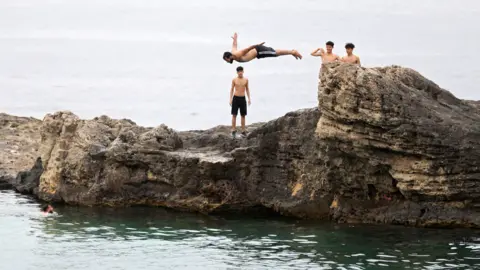 AFP A man diving into the sea in Tripoli, Libya - Friday 30 April 2021