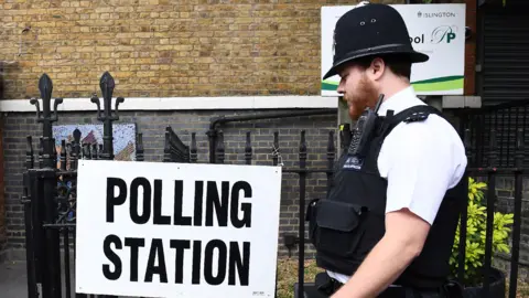 Getty Images Police officer at a polling station