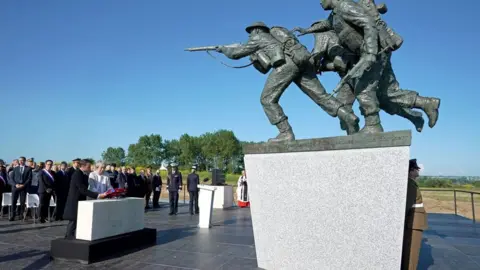 PA Mrs May and Mr Macron lay a wreath together