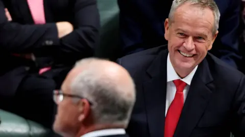 Getty Images Bill Shorten grins across the table at Scott Morrison in parliament
