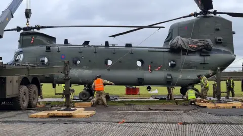 Chinook being lifted from mud