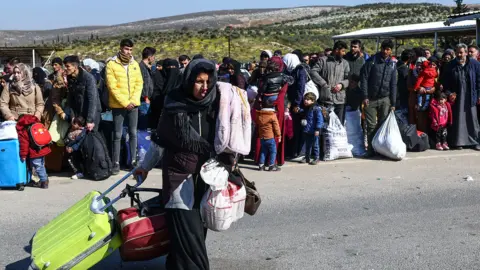 EPA Syrian people at the Cilvegozu border crossing on Thursday