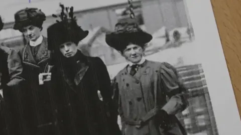 A black and white photo of a group of women