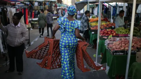 Getty Images A trader carries trays at East Street Market in south London on September 2, 2017