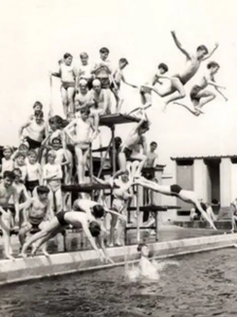Brynaman Lido Committee A black and white photo of boys jumping off the diving board